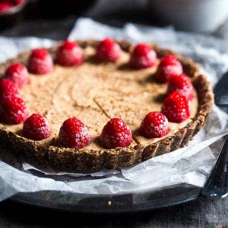 No-Bake Salted Chocolate Tart with Almond Cream - This easy tart is made from almonds and dates, then frozen and filled with almond cream. A healthy and gluten free dessert that can be made in advance! | Foodfaithfitness.com | @FoodFaithFit