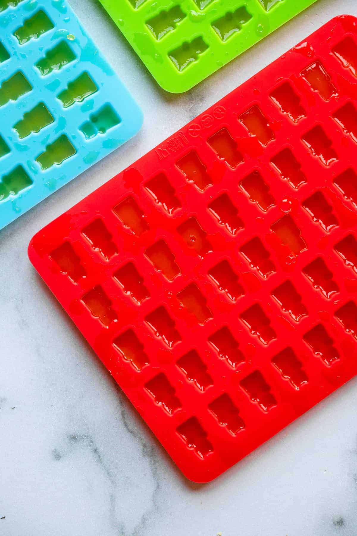 gummy bear mold being filled with healthy gummies