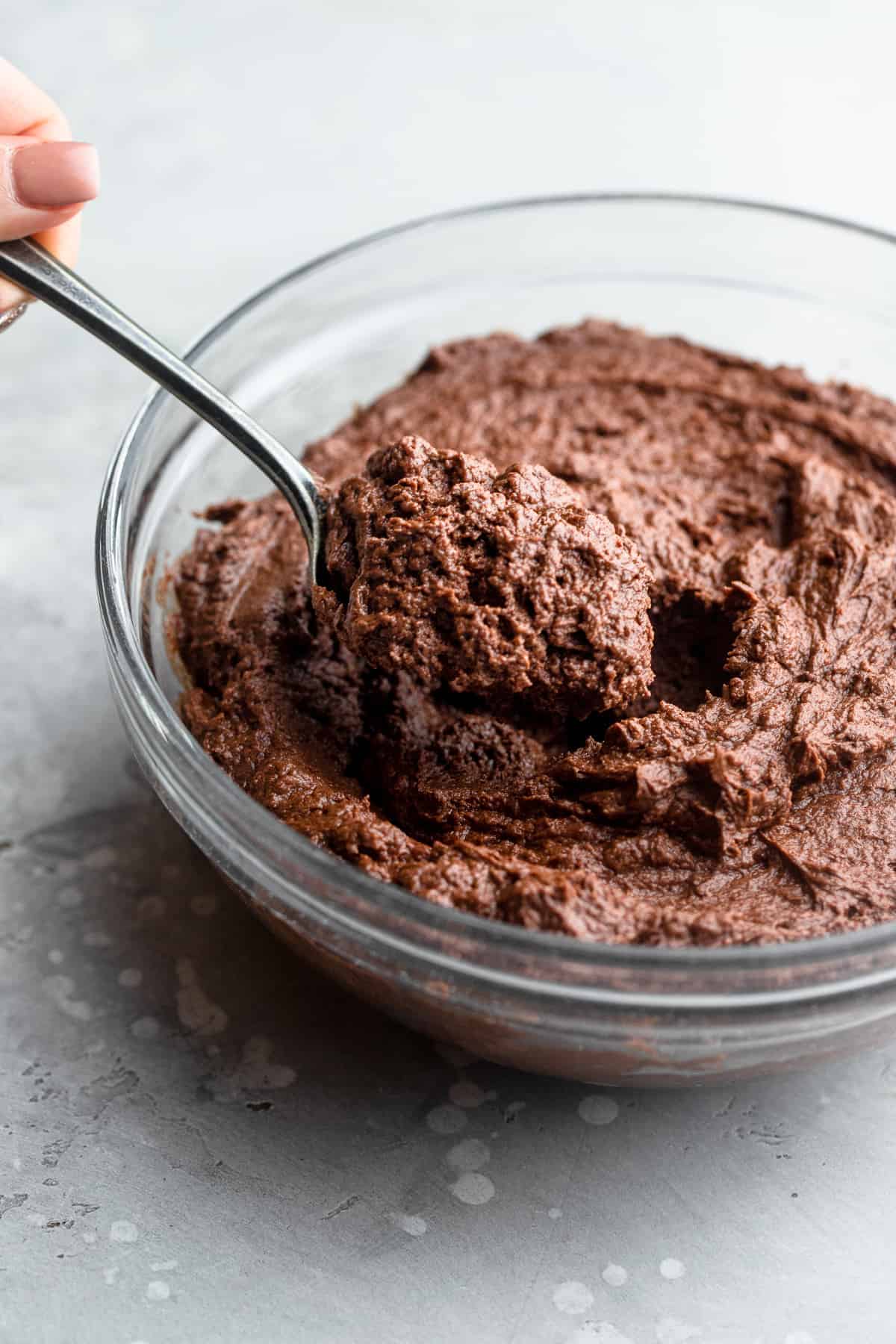 Keto Chocolate Frosting in a bowl being stirred