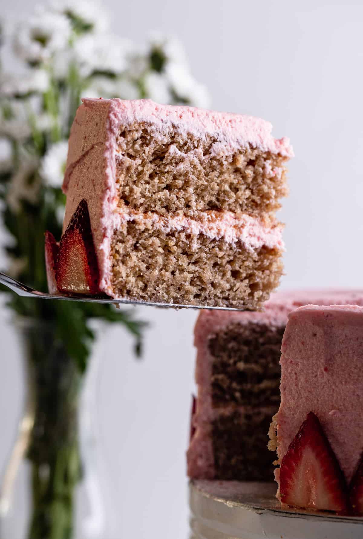a slice of Vegan Strawberry Cake being cut out of a cake