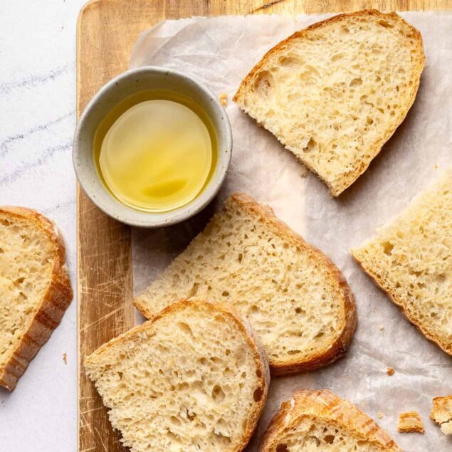 Buttery bread slices with olive oil, fresh baked bread, healthy bread options, food photography, clean eating, nutritious snacks, homemade bread, gluten-free choices, tasty bread recipes, foodie lifestyle, wholesome eating, bakery fresh bread.