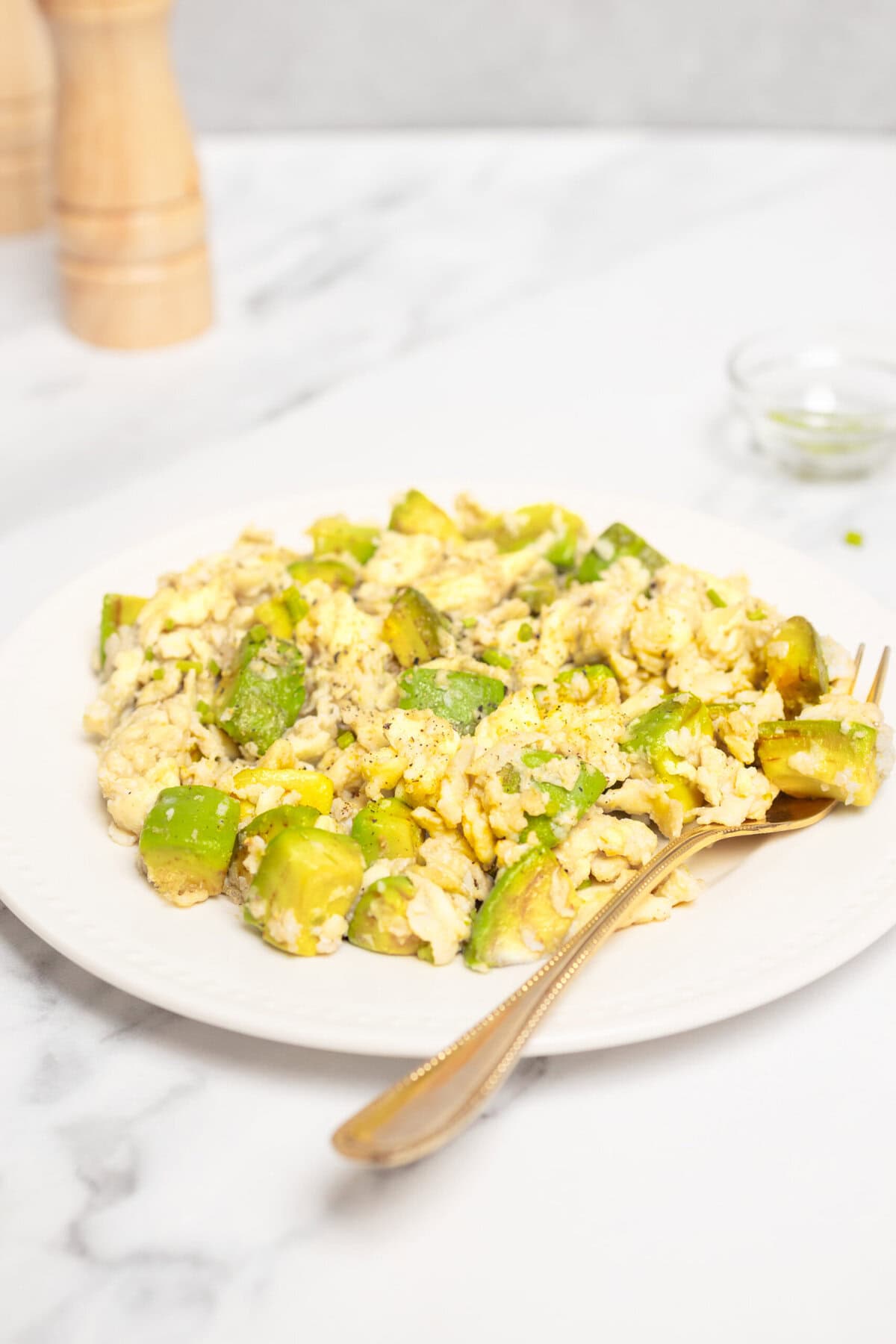 Scrambled eggs with chopped green bell peppers on a white plate, healthy breakfast, high protein, low carb, nutrient-rich meal, fresh food for fitness and wellness, food faith fitness recipe.