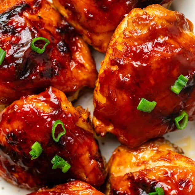 Juicy baked chicken wings coated in barbecue sauce with chopped green onions, perfect for healthy meal options and flavorful recipes.