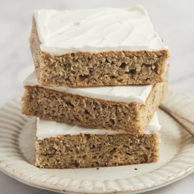 Flourless banana bread bars with cream cheese frosting, healthy gluten-free dessert, perfect for breakfast or snack. Easy-to-make, nutritious, and delicious treat for fitness and wellness.