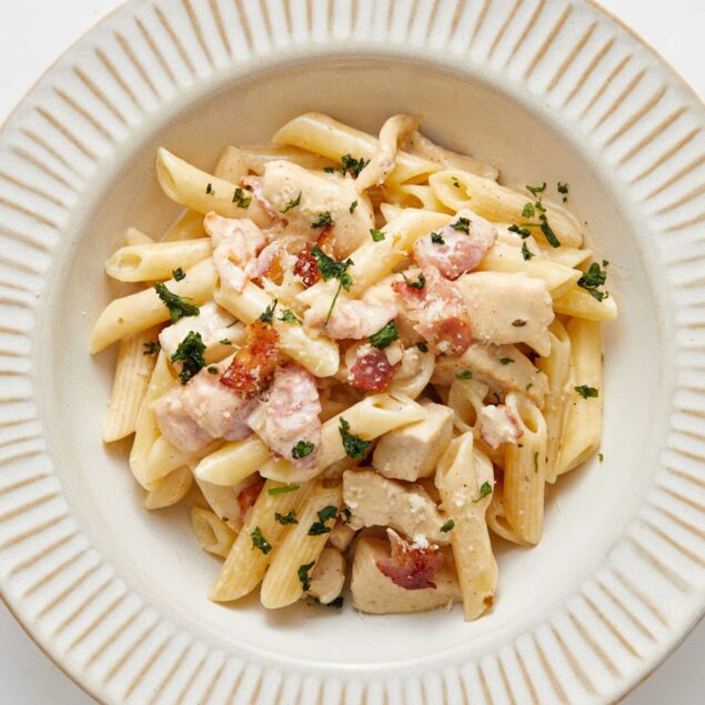 Creamy chicken Alfredo pasta with bacon and fresh herbs, healthy comfort food option, gluten-free pasta recipe from Food Faith Fitness.