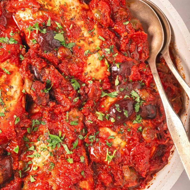 Savory baked chicken thighs in rich tomato sauce with eggplant and herbs, perfect for a healthy, flavorful dinner. Easy baked chicken recipes for a nutritious family meal.