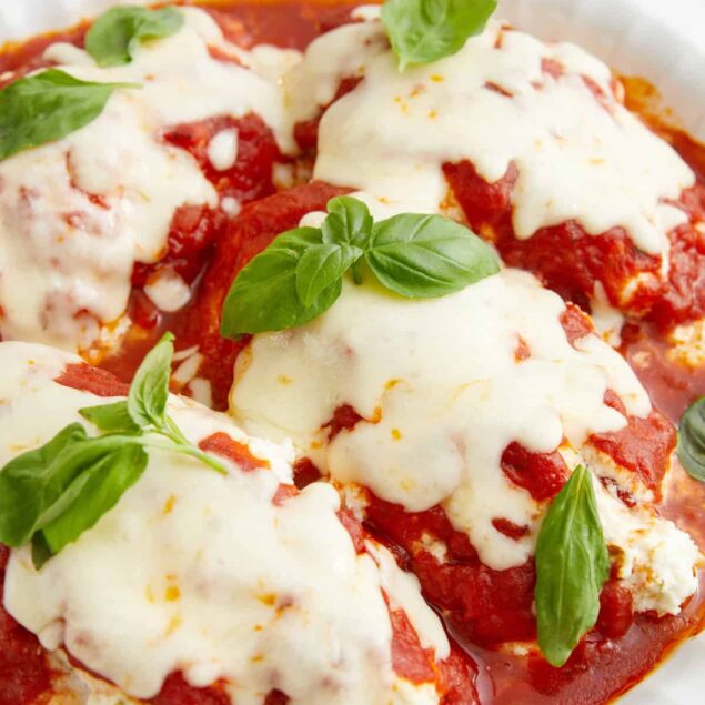 Savory meatballs topped with marinara sauce and melted mozzarella cheese garnished with fresh basil leaves. Healthy, delicious, and easy-to-make Italian comfort food. Perfect for meal prep or family dinner.