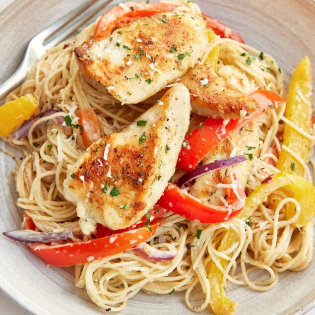 Grilled chicken pasta with colorful bell peppers and fresh herbs, healthy and delicious meal emphasizing balanced nutrition and clean eating from Food Faith Fitness.