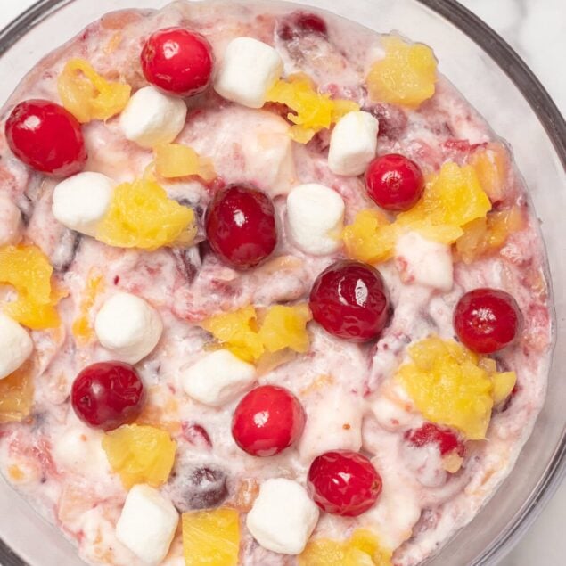 Fresh fruit salad with cherries, pineapple, marshmallows, and yogurt, healthy breakfast idea, high in vitamins and antioxidants. Perfect for a nutritious and colorful start to your day.