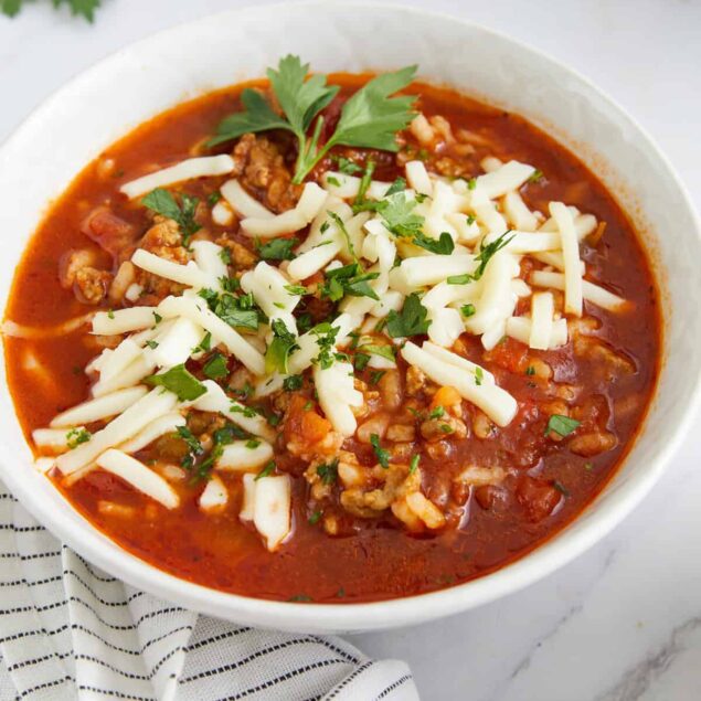Hearty keto chili topped with shredded cheese and fresh herbs, perfect for a healthy, flavorful meal.