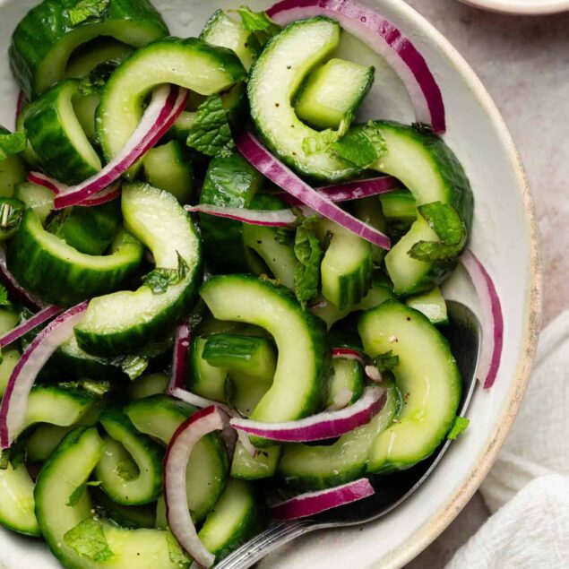 Fresh cucumber and red onion salad with herbs, healthy summer recipes, vegan and low-calorie options.
