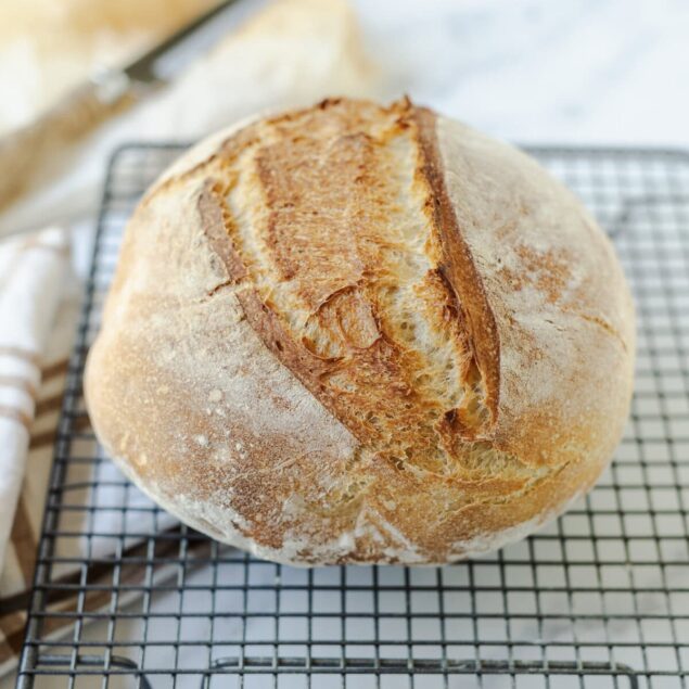 Soft artisan bread loaf on a cooling rack, fresh from baking, ideal for healthy eating and nutritious meal options.