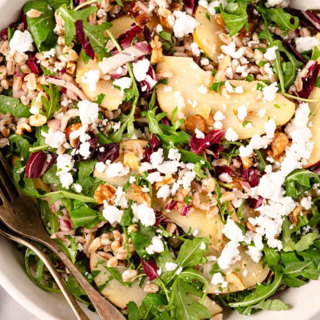 Fresh arugula, pear, and walnut salad with feta cheese, highlighting healthy eating, nutritious recipes, and clean eating tips from Food Faith Fitness. Perfect for balanced meal ideas.