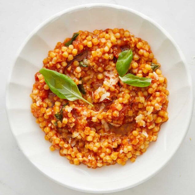 Roasted tomato basil chickpea stew in a white bowl, healthy vegan gluten-free vegetarian meal.