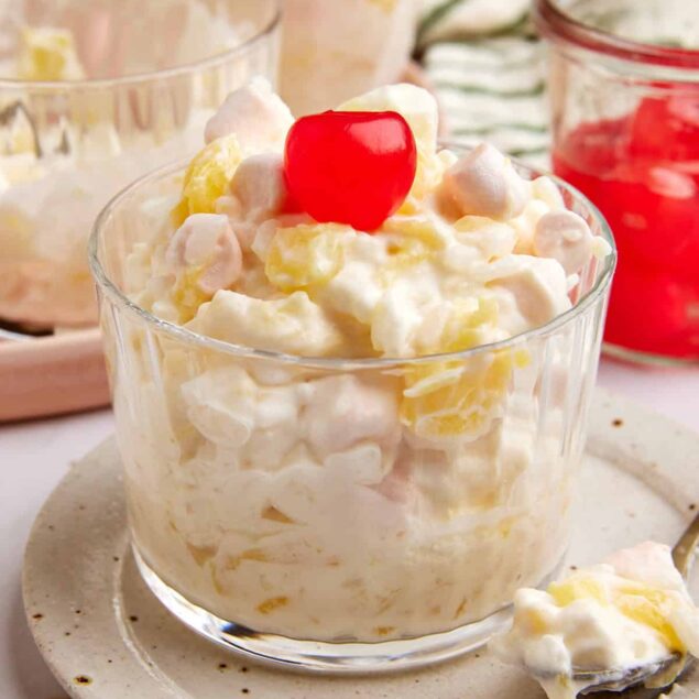 Creamy banana pudding with whipped topping and maraschino cherry, healthy dessert idea, perfect for snack or special occasion.