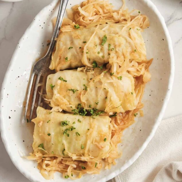Savoy cabbage rolls stuffed with lean meat and vegetables served with sauerkraut, showcasing healthy, protein-packed recipes for balanced meal planning.
