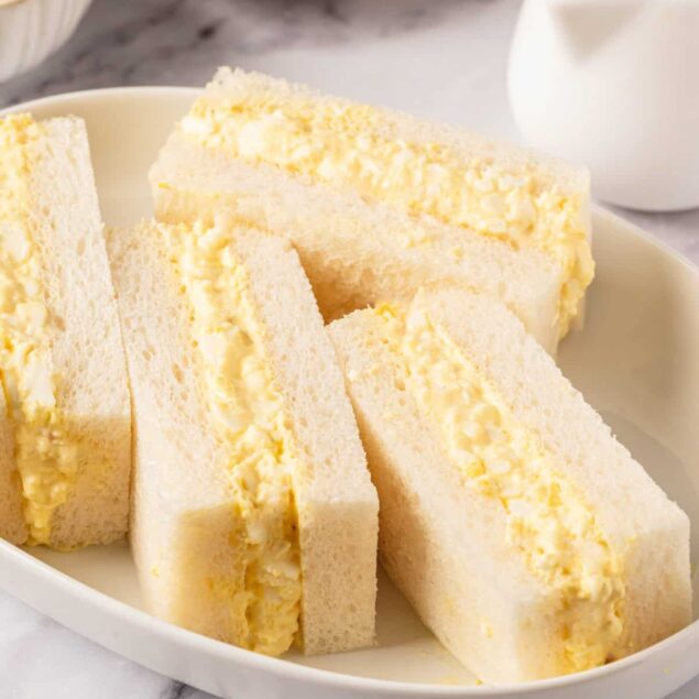 Fluffy egg salad sandwiches on white bread with butter and mayonnaise background, healthy food ideas, easy breakfast or lunch recipes, protein-packed snack, Food Faith Fitness kitchen.