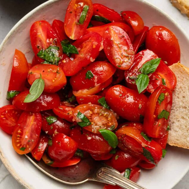 Fresh cherry tomato salad with basil and olive oil for healthy recipes and nutritious eating.