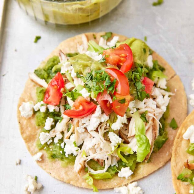 Flavorful grilled chicken tacos with fresh tomatoes, shredded cheese, and avocado on whole wheat tortillas, perfect for healthy meal prep and nutritious eating.