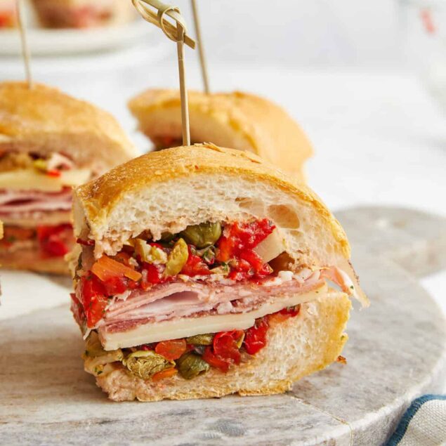 Fresh Italian dip sandwich with layers of ham, cheese, roasted red peppers, and pickled vegetables on a crusty bread roll, perfect for a healthy, delicious meal or snack.