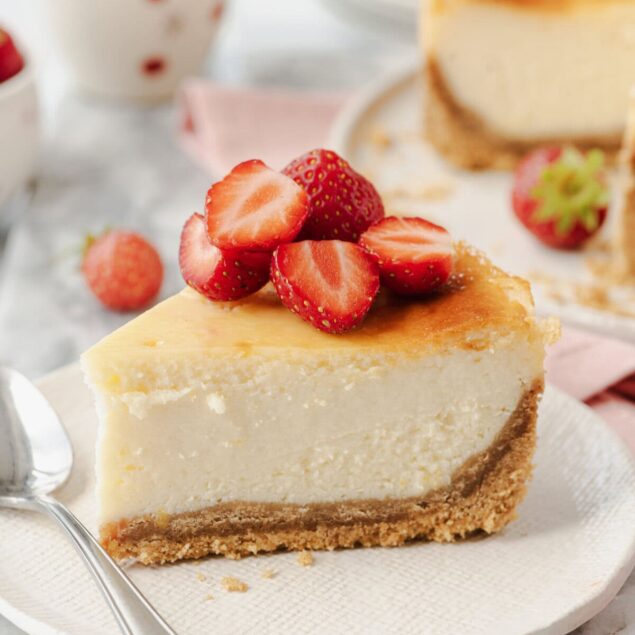 Rich and creamy cheesecake topped with fresh strawberries, perfect for healthy desserts and indulgent treats. Ideal for gluten-free and low-carb diet options, made with wholesome ingredients.