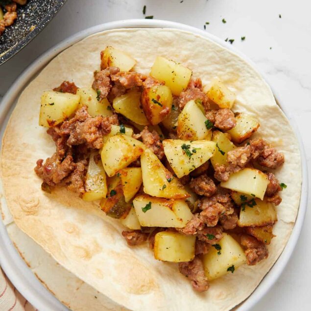 Savory potato and ground beef filling on a soft tortilla, perfect for healthy dinners or meal prep, from Food Faith Fitness.