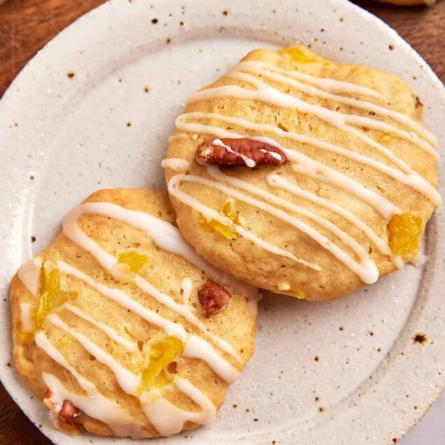 Fluffy lemon blueberry scones drizzled with vanilla glaze, served on a rustic white plate, perfect for healthy breakfast or brunch suggestions from Food Faith Fitness.
