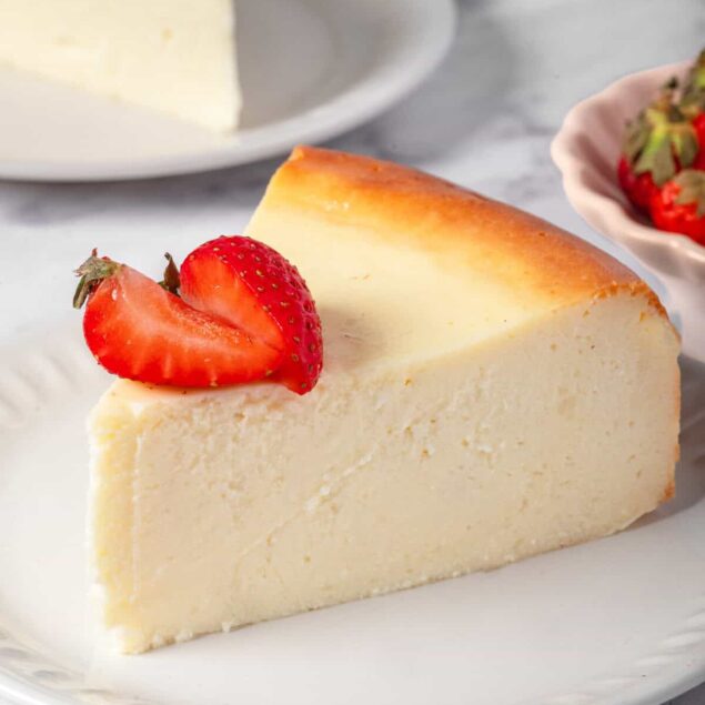 Creamy New York style cheesecake topped with fresh strawberries, perfect for a healthy dessert or snack. Made with simple ingredients, it's delicious and vegetarian-friendly.