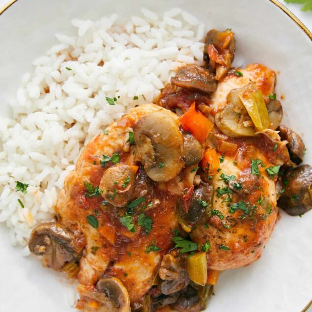 Hearty baked chicken breast with mushroom and vegetable sauce served with white rice, healthy dinner recipe, gluten-free and flavorful.