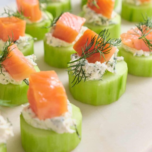 Fresh cucumber bites topped with smoked salmon, cottage cheese, and dill for a healthy, nutritious snack or appetizer. Perfect for balanced eating and fitness-focused meals from Food Faith Fitness.