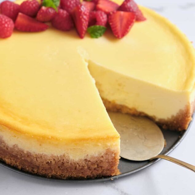 Creamy lemon cheesecake topped with fresh strawberries and mint. A delicious healthy dessert recipe perfect for guilt-free indulgence and satisfying your sweet tooth.