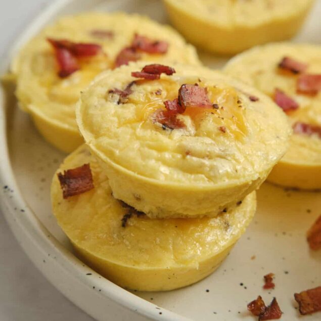 Creamy breakfast egg muffins with crispy bacon bits on top, perfect for a healthy morning meal. These savory egg muffins are easy to make and packed with high-protein ingredients.