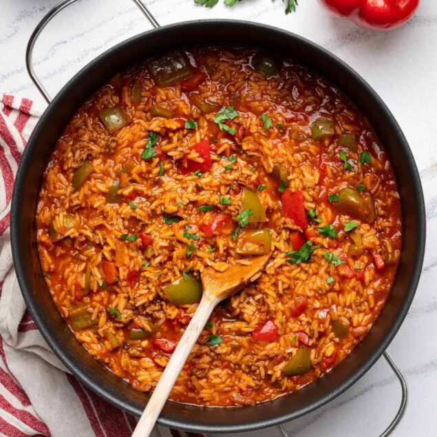 Savory vegetable rice skillet with bell peppers, tomatoes, and herbs, perfect for healthy meal prep and balanced eating. Nutrient-rich, flavorful, and easy to make.