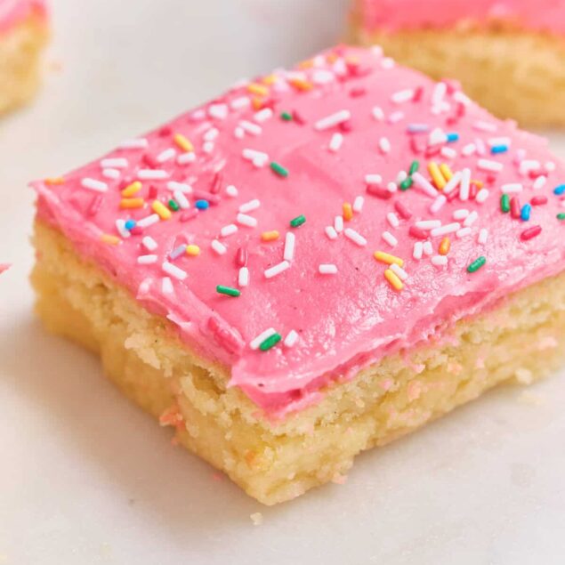 Bright pink frosted sugar cookie squares with colorful sprinkles, perfect for healthy treats and dessert ideas.