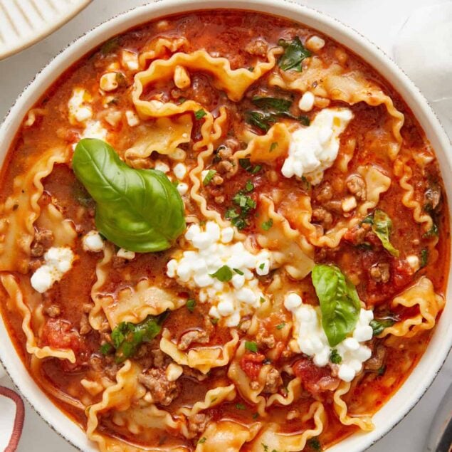 Creamy tomato and ground beef stuffed pasta in a flavorful sauce with fresh basil and ricotta cheese, perfect for healthy, comfort food recipes from Food Faith Fitness.