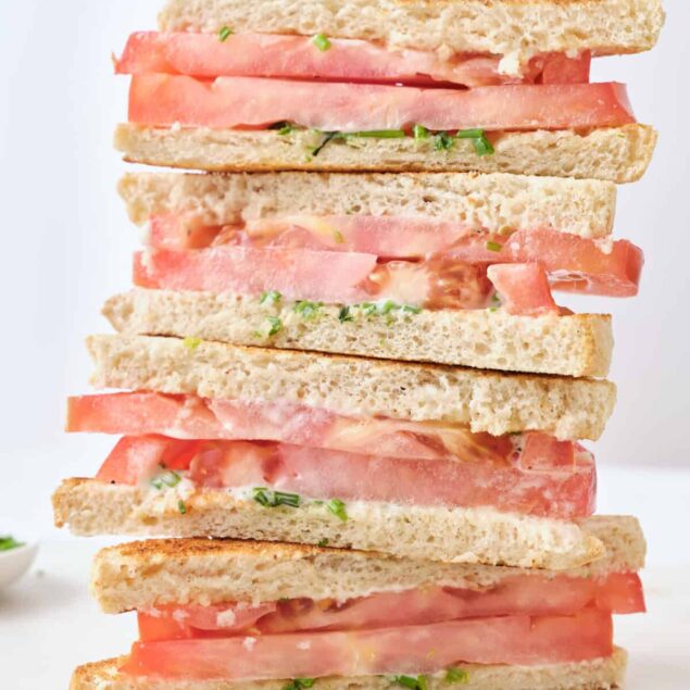 Fresh tomato and whole grain sandwich on white background, healthy and nutritious meal, easy lunch idea, gluten-free bread, clean eating, food faith fitness, plant-based diet, vitamin-rich ingredients.