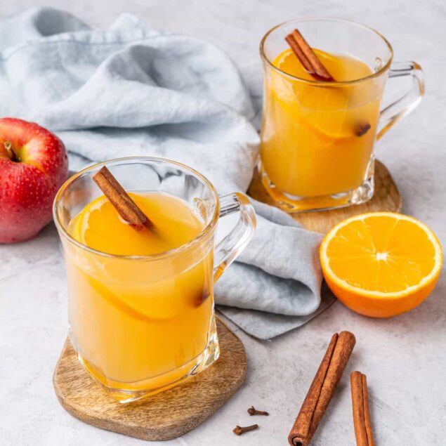 Refreshing homemade orange cinnamon spice tea with fresh orange slices and cinnamon sticks. Perfect for a healthy, immune-boosting beverage.