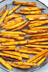 air fried sweet potato fries on a mesh basket