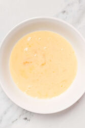 Creamy scrambled eggs in a white bowl, perfect for healthy breakfast recipes and high-protein nutrition.