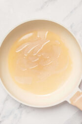 Creamy chicken broth soup in a white bowl, healthy comfort food, low-calorie and nourishing, perfect for weight loss, clean eating, and balanced diet, featured on Food Faith Fitness.