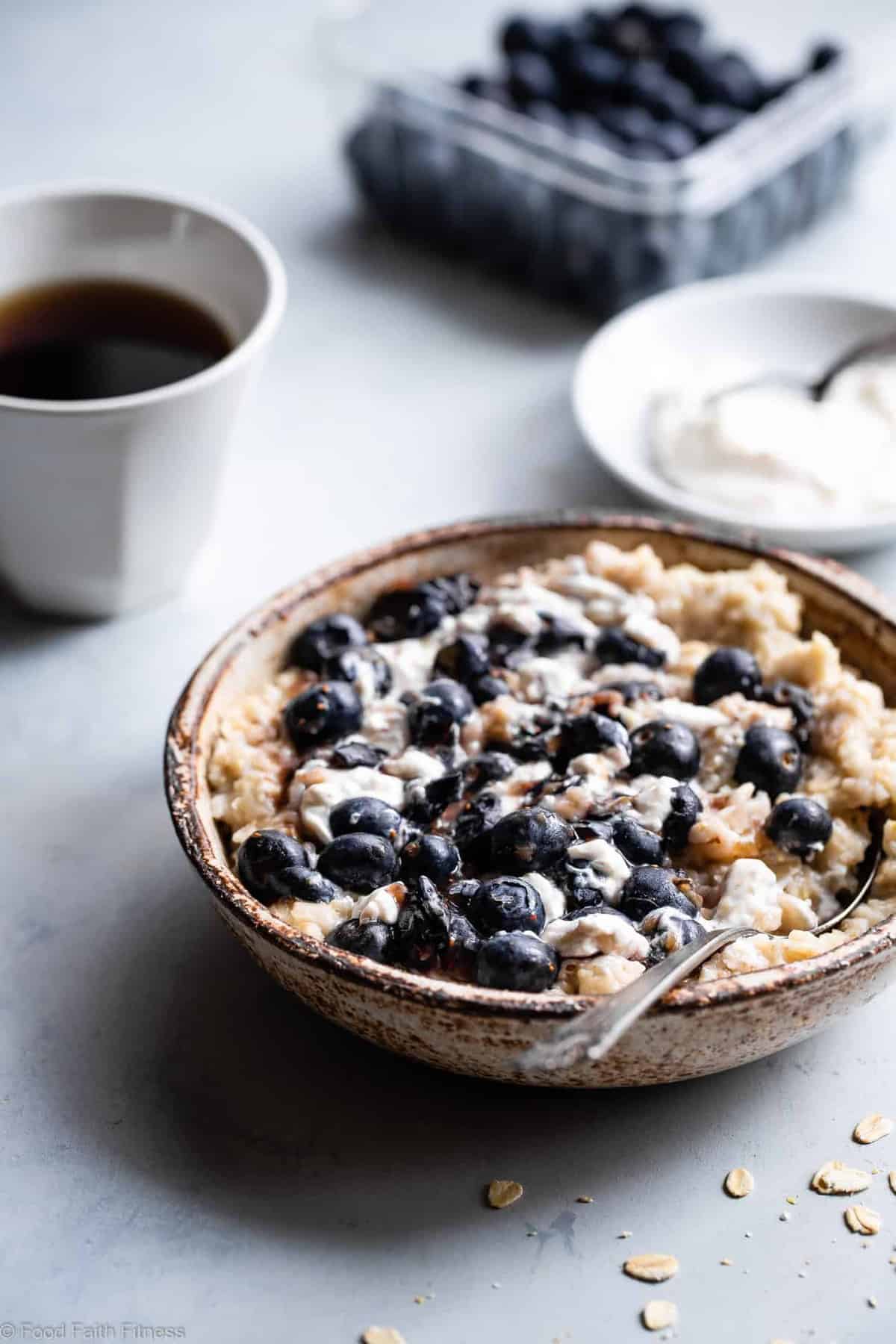 Blueberry Cheesecake Oatmeal - This quick and easy Blueberry Oatmeal with Cheesecake Swirl is a healthy, low fat and gluten free breakfast that tastes like waking up to cheesecake! | #Foodfaithfitness |