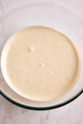 Creamy homemade almond milk in a glass bowl, a healthy dairy-free milk alternative, perfect for recipes or smoothies.
