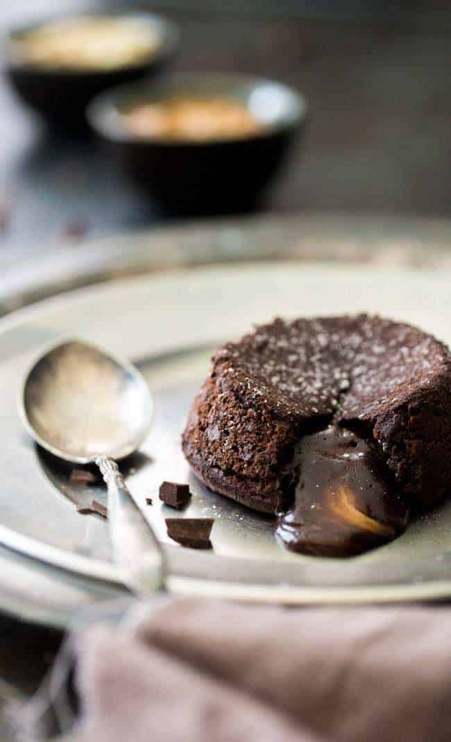 Paleo Chocolate Lava Cake Recipe - So rich and chocolatey that you would NEVER know these are healthy! They’re made with coconut oil and almond butter, so they taste like an Almond Joy bar! Perfect for Valentine’s Day!