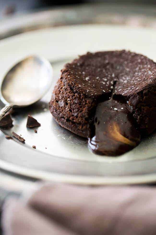 Paleo Chocolate Lava Cake Recipe - So rich and chocolatey that you would NEVER know these are healthy! They’re made with coconut oil and almond butter, so they taste like an Almond Joy bar! Perfect for Valentine’s Day!