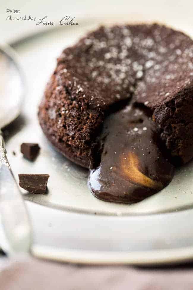 Paleo Chocolate Lava Cake Recipe - So rich and chocolatey that you would NEVER know these are healthy! They’re made with coconut oil and almond butter, so they taste like an Almond Joy bar! Perfect for Valentine’s Day!