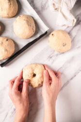 Soft homemade blueberry bagel dough balls on marble surface, ready to bake, emphasizing healthy baking recipes from Food Faith Fitness.