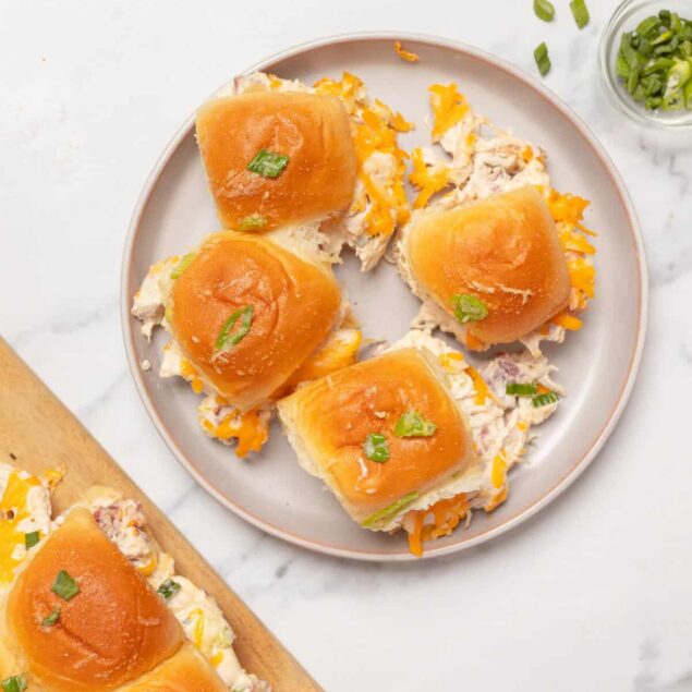 Creamy chicken and shredded cheese stuffed Hawaiian bread rolls garnished with green onions for a delicious, healthy meal or snack. Perfect for meal prep or family gatherings.