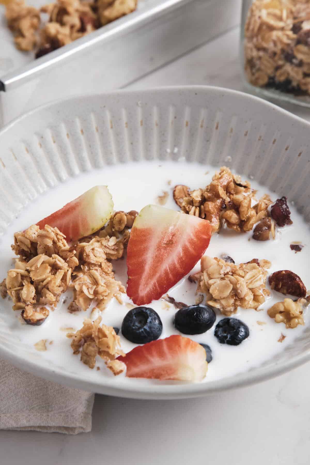 Fresh homemade granola yogurt parfait with strawberries, blueberries, and oats, perfect for a healthy breakfast or snack, featuring nutritious ingredients for a balanced diet.