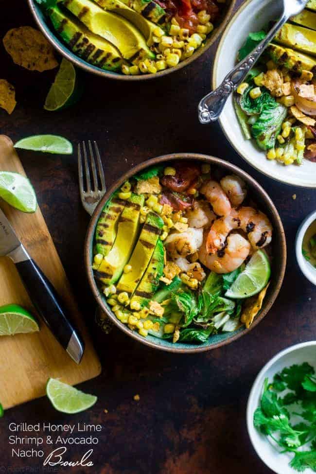 Honey Lime Grilled Avocado Shrimp Nacho Bowls - These smoky-sweet bowls have glazed honey lime grilled avocado, spicy shrimp. tomato and corn! Top them with gluten free nacho chips for a healthy, summer meal that's packed with flavor! | Foodfaithfitness.com | @FoodFaithFit