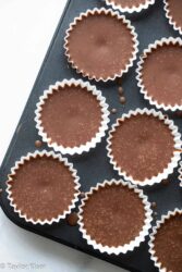 chocolate peanut butter keto fat bombs in a muffin tin